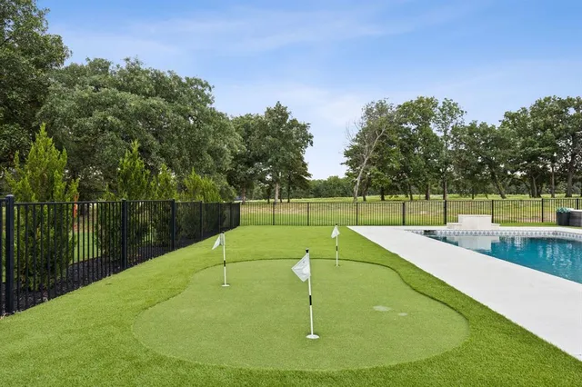 a view of a backyard with swimming pool