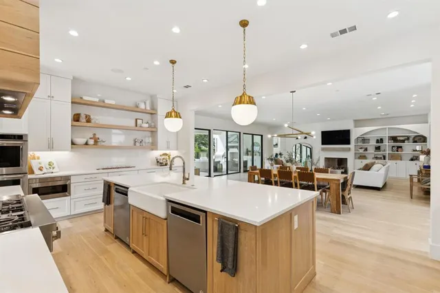 a large kitchen with a large counter top appliances and cabinets