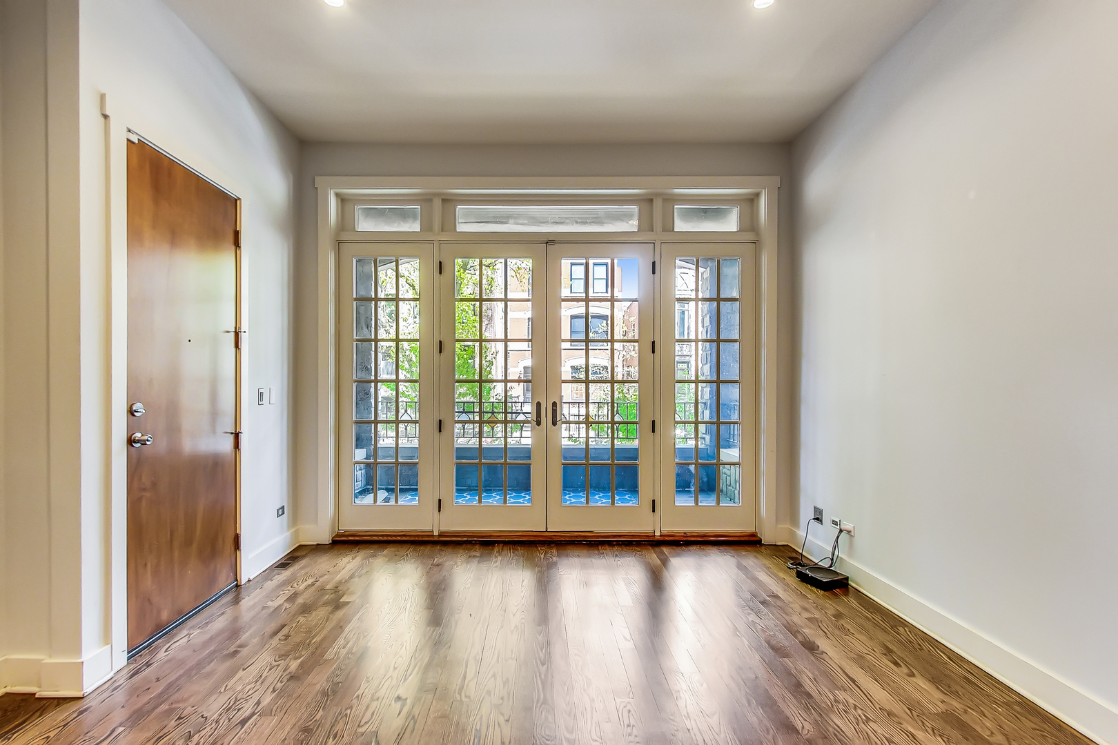 619 West Surf Street, Unit 1 Chicago, IL 60657 - Photo 11 of 36 wooden floor in an empty room with a window