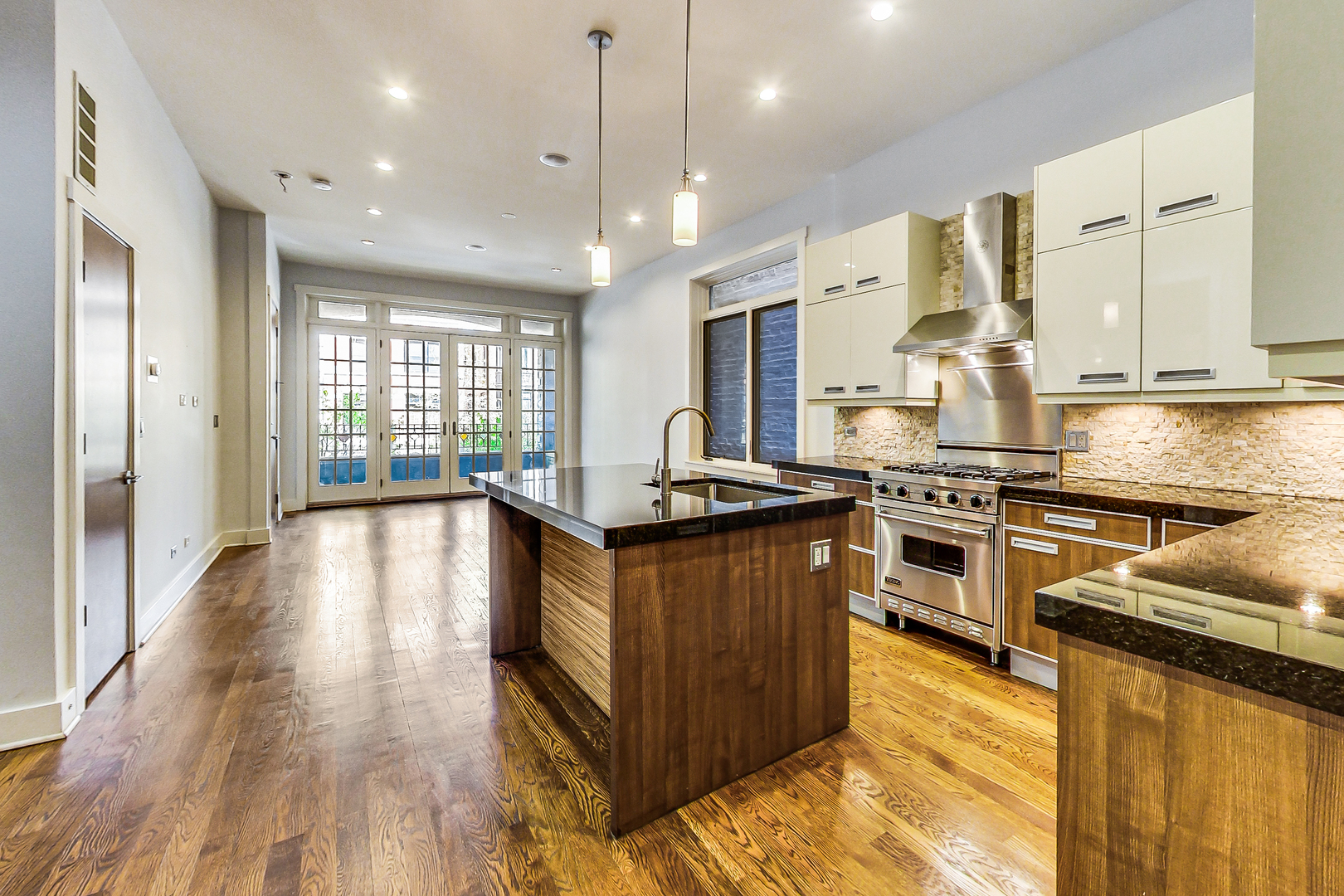 619 West Surf Street, Unit 1 Chicago, IL 60657 - Photo 13 of 36 a kitchen with stainless steel appliances granite countertop a stove and a wooden floors