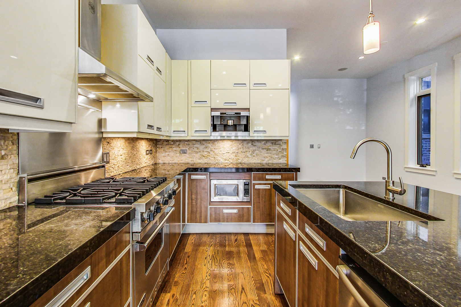 619 West Surf Street, Unit 1 Chicago, IL 60657 - Photo 14 of 36 a kitchen with granite countertop a sink stove and cabinets