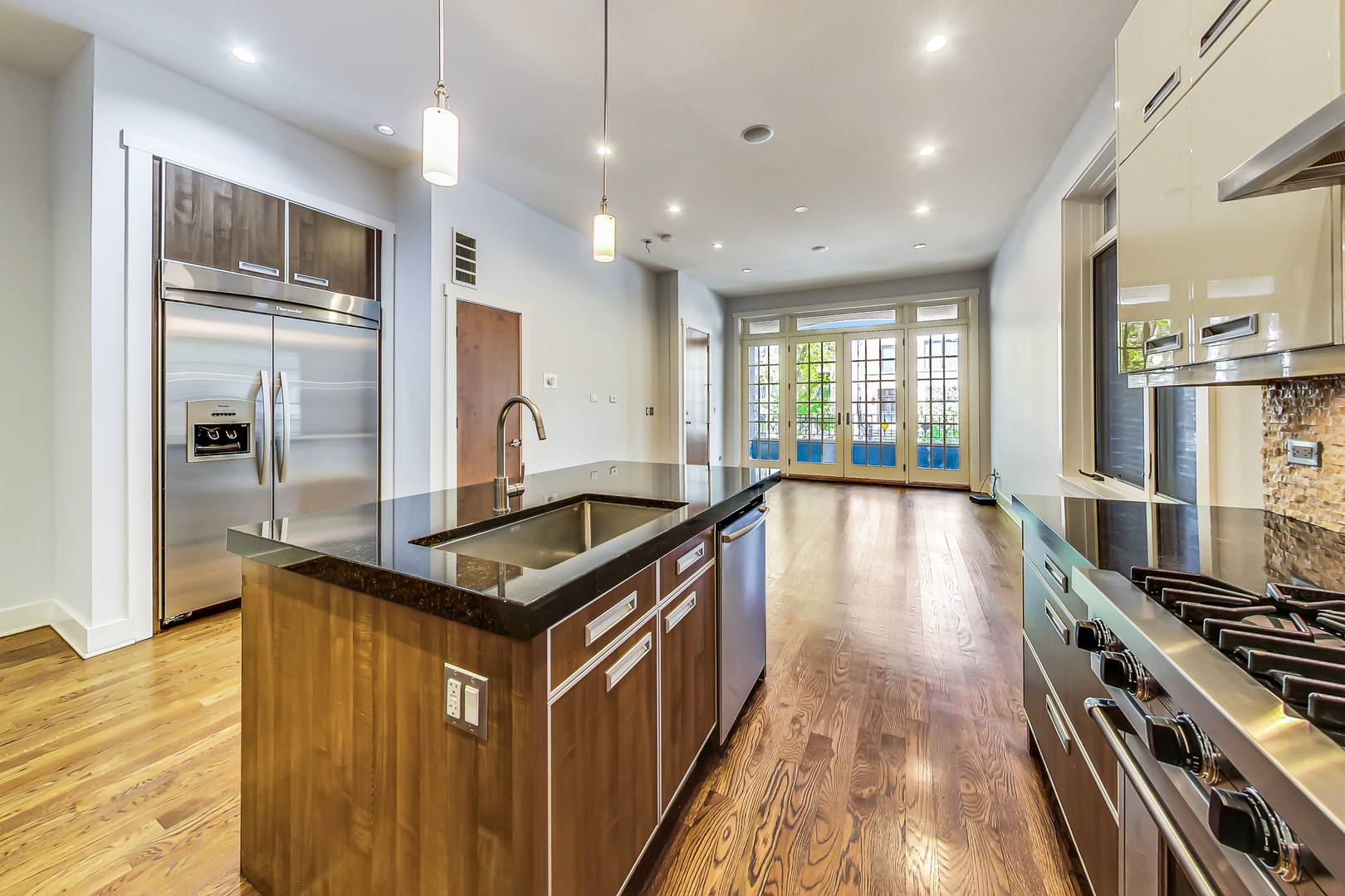 619 West Surf Street, Unit 1 Chicago, IL 60657 - Photo 15 of 36 a kitchen with stainless steel appliances granite countertop a stove top oven a sink and a refrigerator