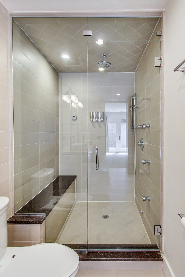 619 West Surf Street, Unit 1 Chicago, IL 60657 - Photo 22 of 36 a bathroom with a shower a toilet and sink