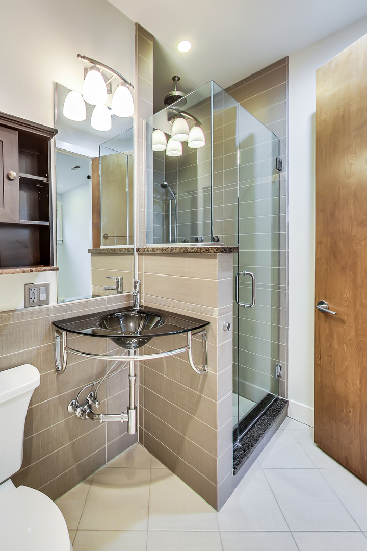 619 West Surf Street, Unit 1 Chicago, IL 60657 - Photo 25 of 36 a bathroom with a sink and a mirror