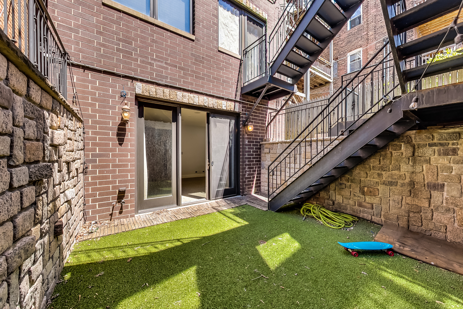 619 West Surf Street, Unit 1 Chicago, IL 60657 - Photo 34 of 36 a view of a house with a yard