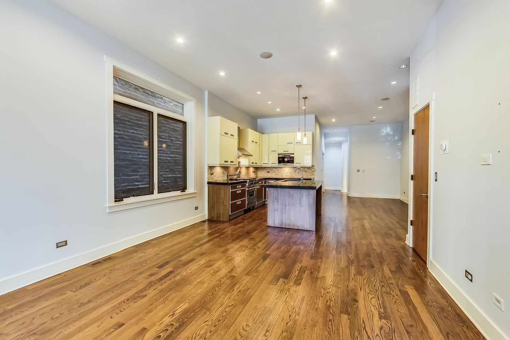 619 West Surf Street, Unit 1 Chicago, IL 60657 - Photo 10 of 36 a open kitchen with stainless steel appliances granite countertop a stove and a wooden floors