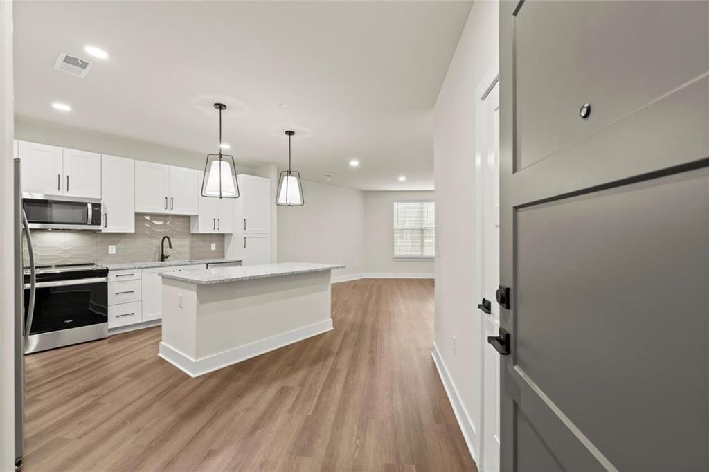 2648 Sandy Plains Road, Unit 422 Marietta, GA 30066 - Photo 2 of 37 a large kitchen with a lot of counter space and stainless steel appliances