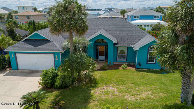 303 Genoa Road St. Augustine, FL 32084 - Photo 1 of 22 a front view of a house with a yard and garage