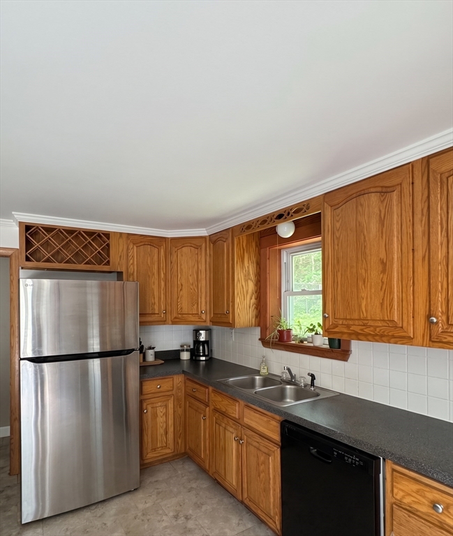 27 High Street Sturbridge, MA 01518 - Photo 13 of 17 a kitchen with stainless steel appliances granite countertop a refrigerator sink and cabinets