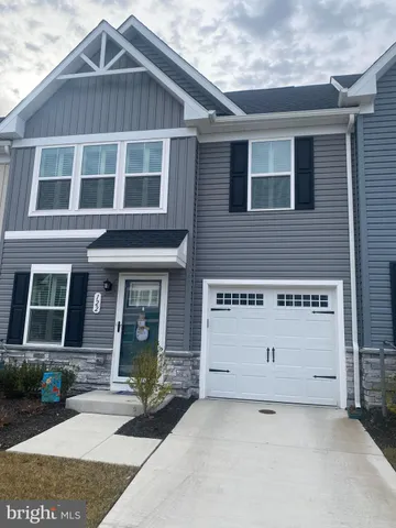 a front view of a house with garage
