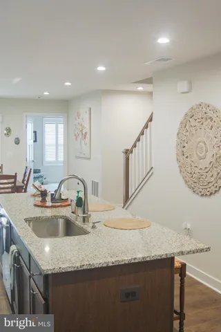 a kitchen with a sink a stove and cabinets