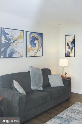 a living room with furniture and wall painting