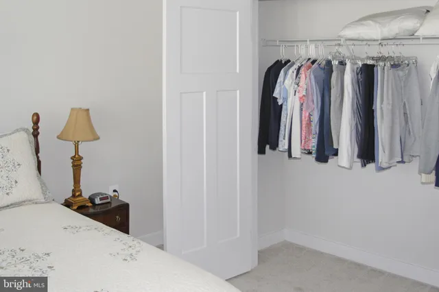 a view of walk in closet with clothes