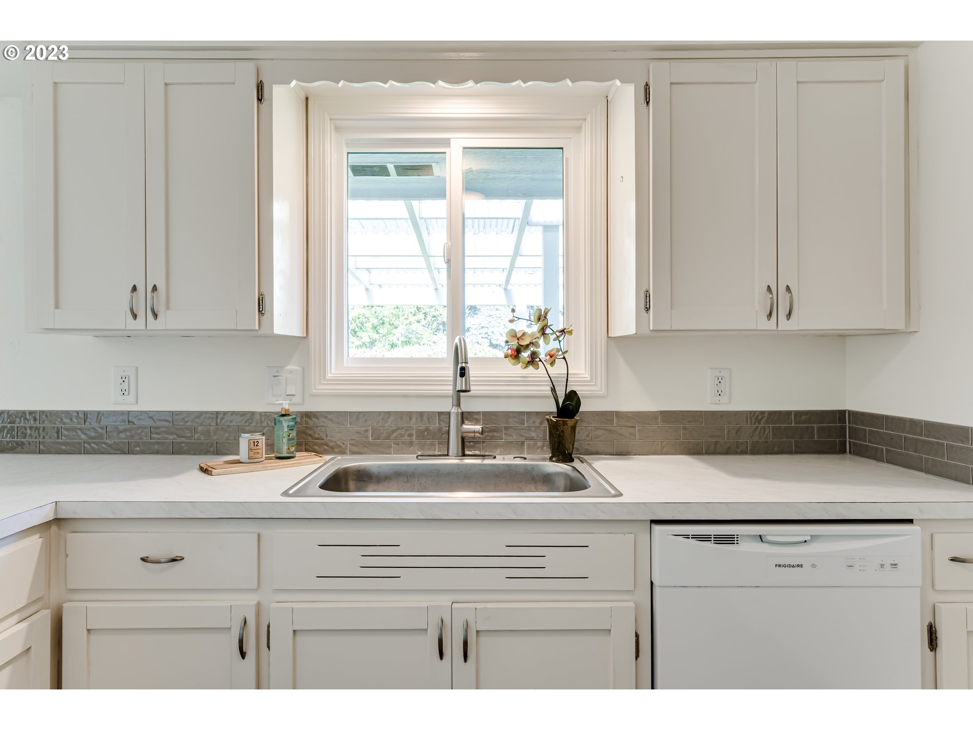 2548 16th Street Springfield, OR 97477 - Photo 11 of 35 a kitchen with granite countertop white cabinets and white appliances