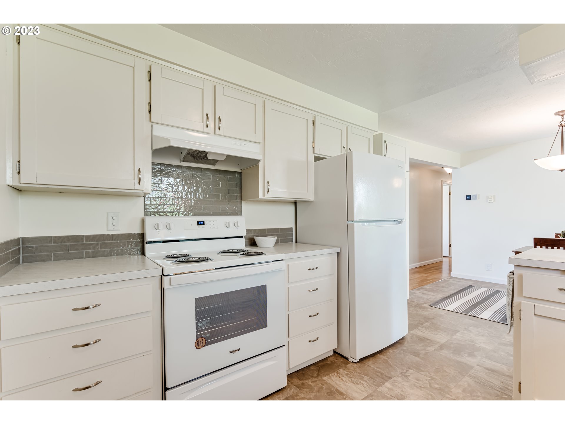 2548 16th Street Springfield, OR 97477 - Photo 12 of 35 a kitchen with stainless steel appliances white cabinets and a refrigerator