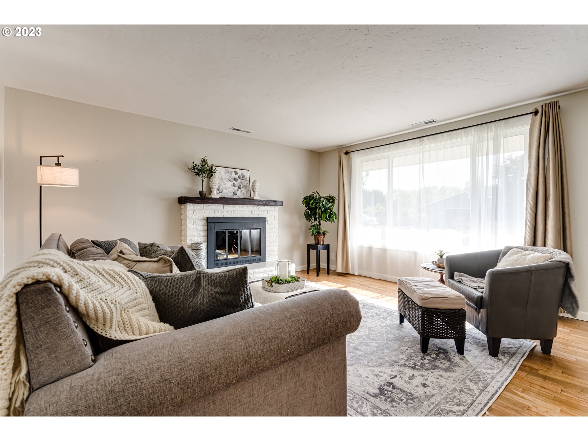 2548 16th Street Springfield, OR 97477 - Photo 6 of 35 a living room with furniture a large window and a fireplace
