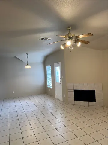 a view of a livingroom with a ceiling fan and window