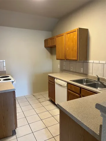 a kitchen with stainless steel appliances granite countertop a sink and a stove