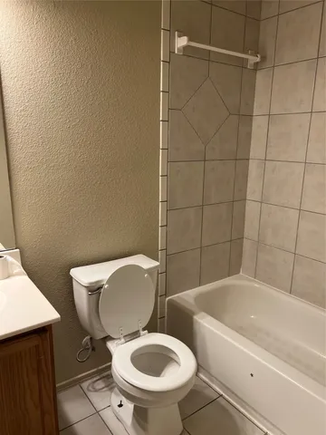 a white toilet sitting next to a bath tub