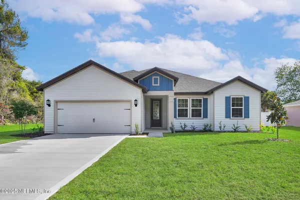 a front view of house with yard and green space