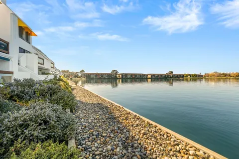 a view of a lake with houses in the back