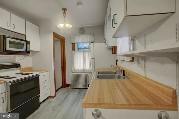 a kitchen with wooden cabinets and stainless steel appliances