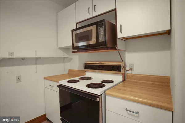 a kitchen with a stove and a microwave
