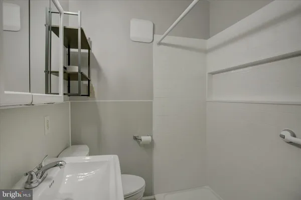 a bathroom with a toilet sink and shower