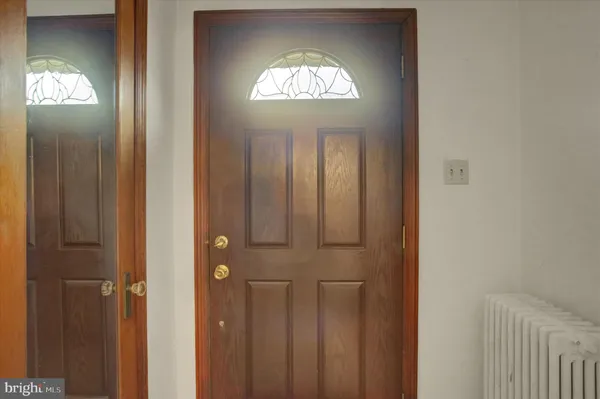 a view of a hallway with windows chandelier front door