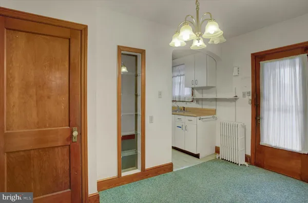 a kitchen with white cabinets and sink