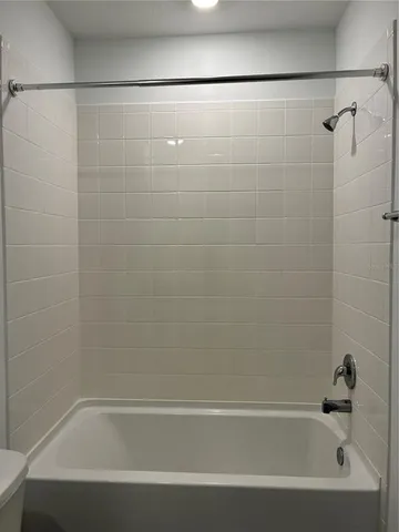 a bathroom with a shower and a bath tub