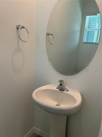 a bathroom with a sink and mirror