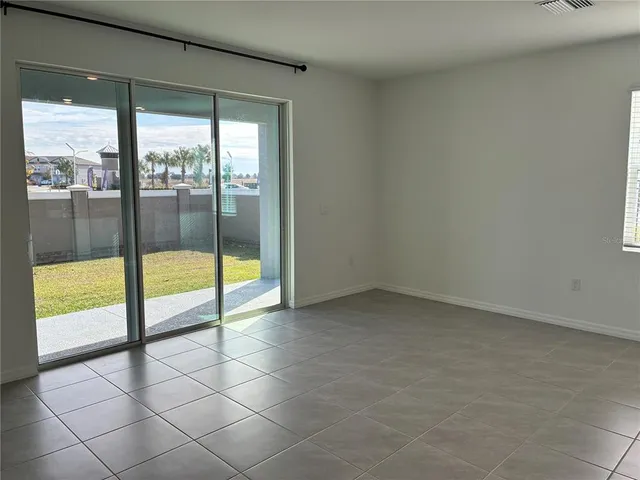 a view of an empty room with a floor to ceiling window