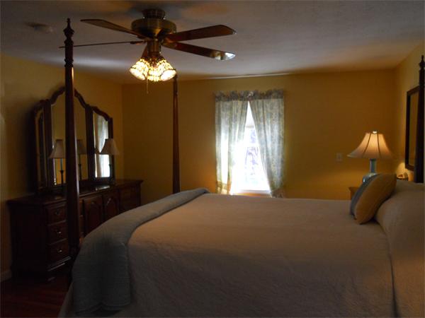 60 Beachview Road Lunenburg, MA 01462 - Photo 11 of 18 a bedroom with a bed and a chandelier