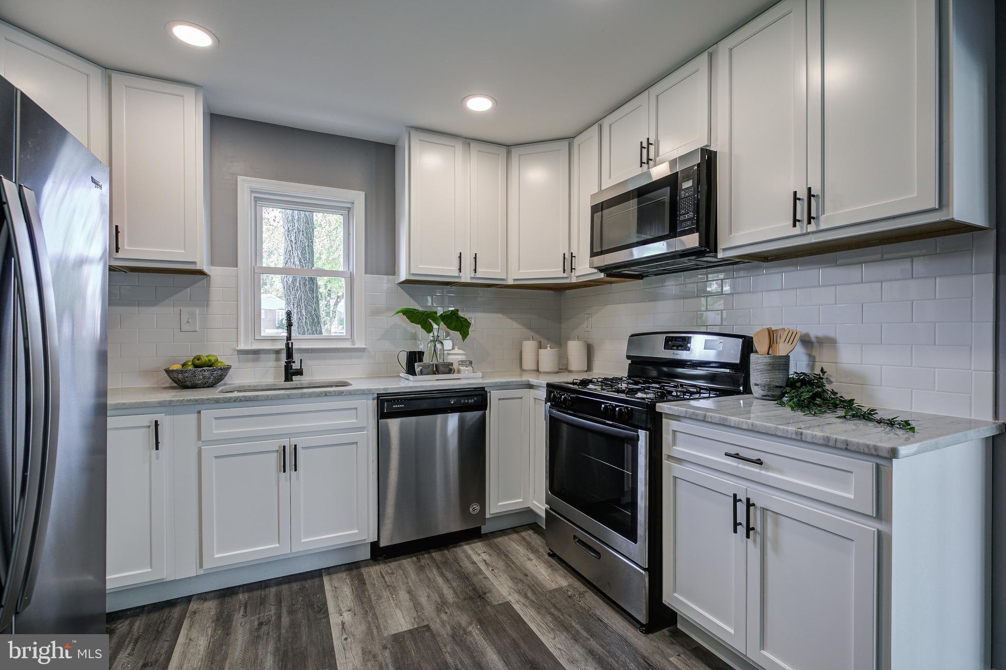 7410 Remoor Road Baltimore, MD 21207 - Photo 12 of 33 a kitchen with stainless steel appliances granite countertop a sink a stove a refrigerator and cabinets