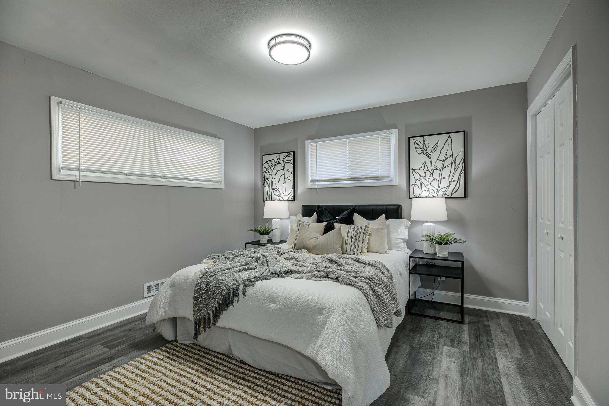 7410 Remoor Road Baltimore, MD 21207 - Photo 16 of 33 a bedroom with a bed and wooden floor