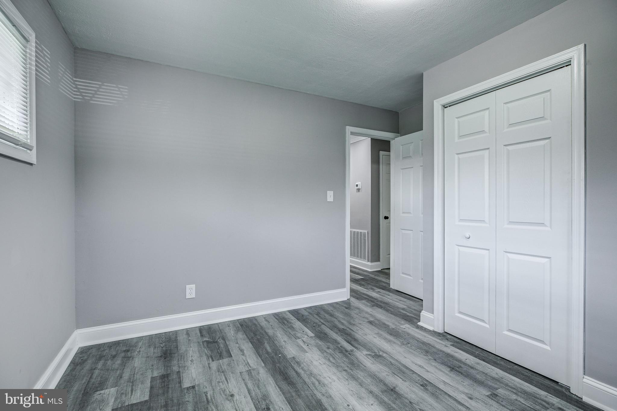7410 Remoor Road Baltimore, MD 21207 - Photo 20 of 33 an empty room with wooden floor and windows