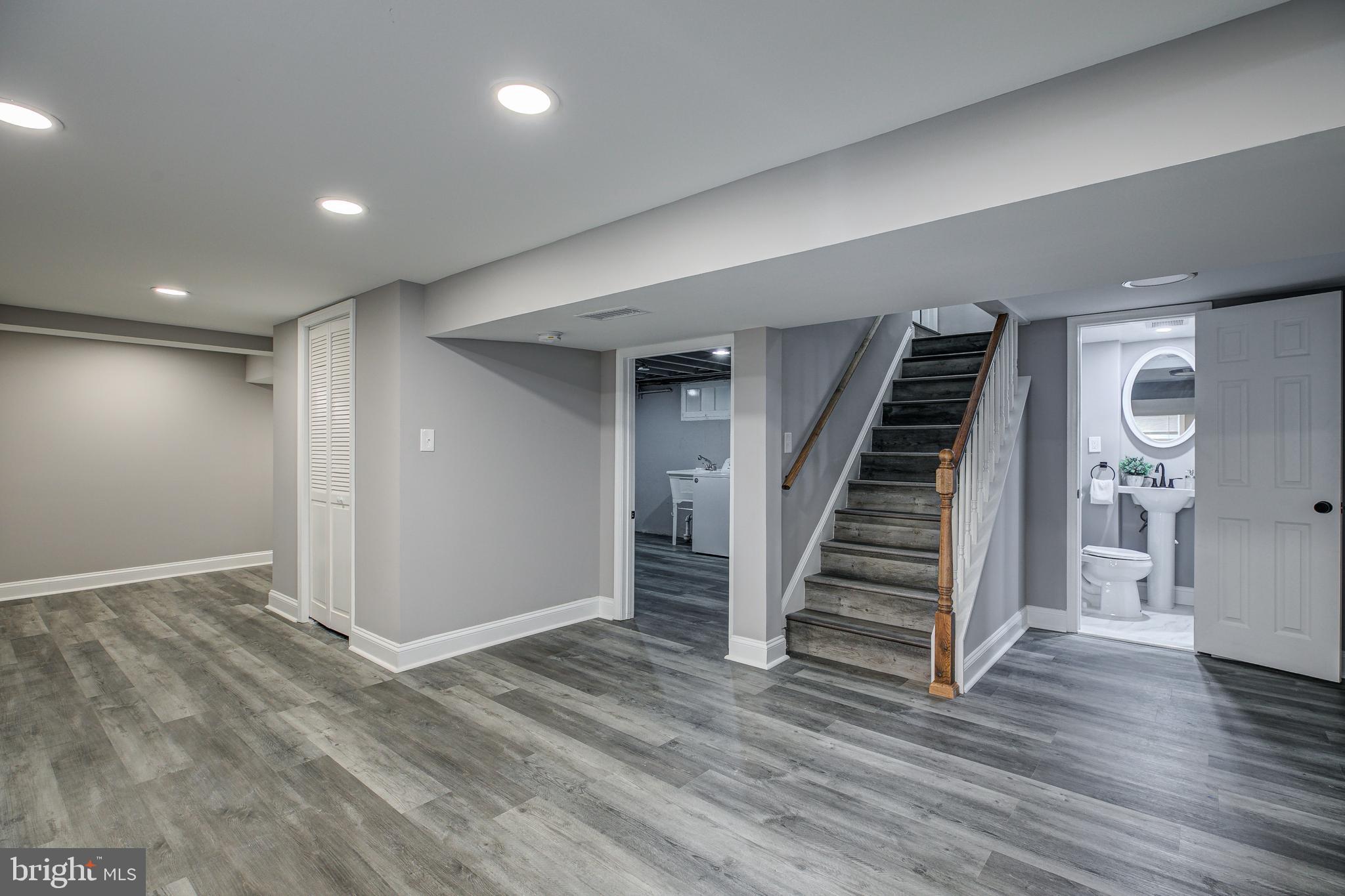 7410 Remoor Road Baltimore, MD 21207 - Photo 23 of 33 an empty room with wooden floor and stairs