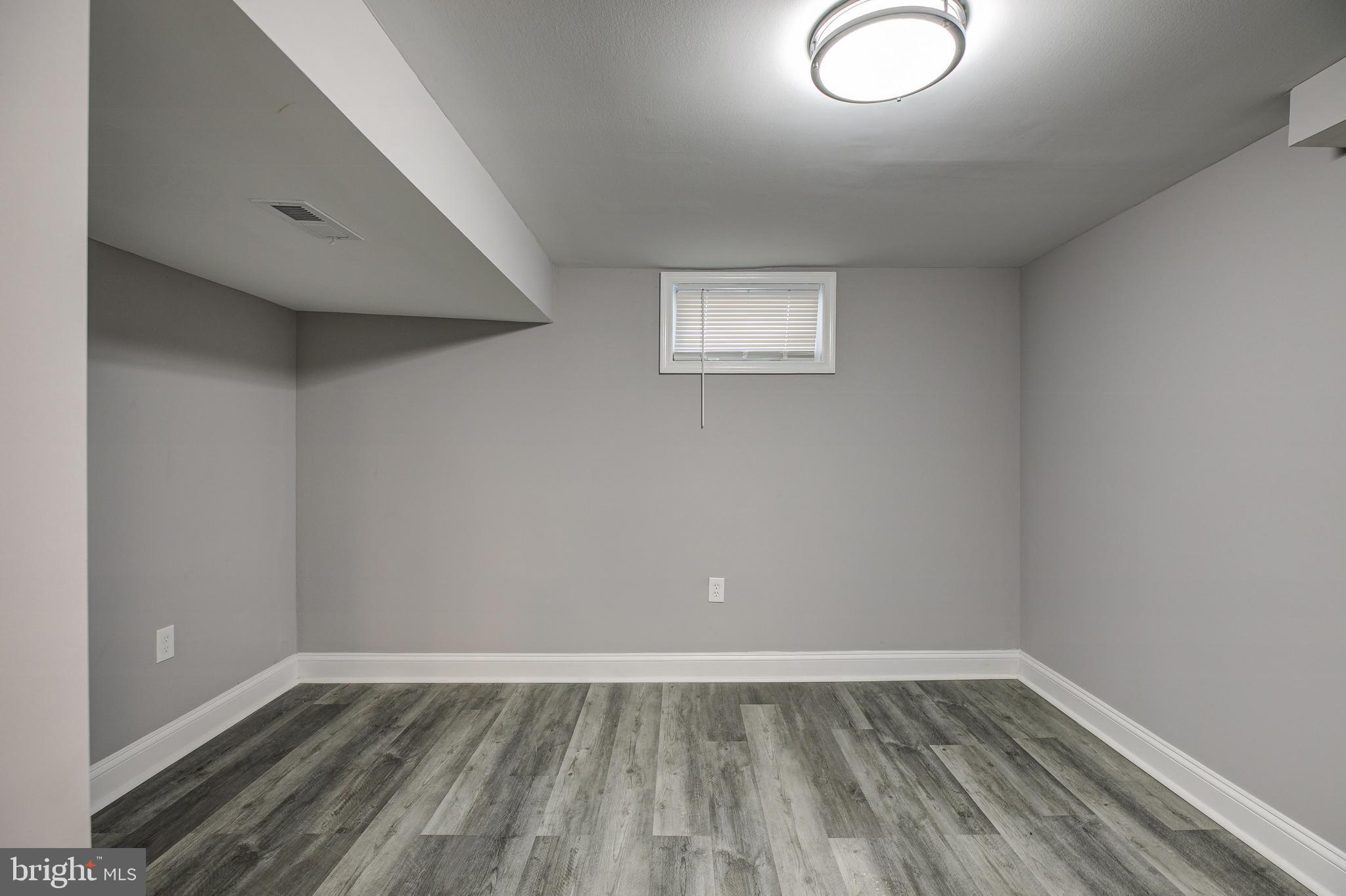 7410 Remoor Road Baltimore, MD 21207 - Photo 25 of 33 a view of an empty room with wooden floor and a window