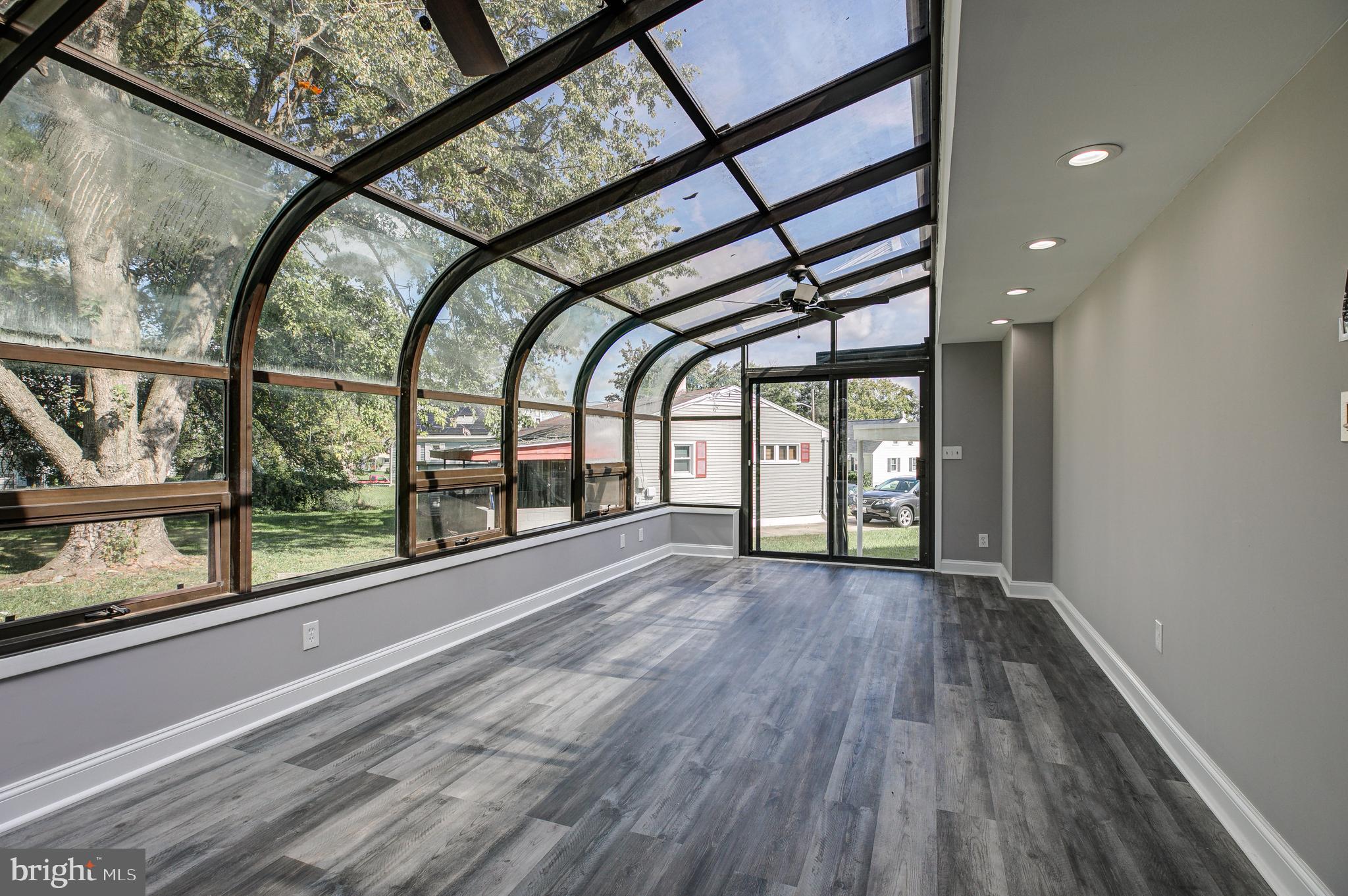 7410 Remoor Road Baltimore, MD 21207 - Photo 30 of 33 en empty room with wooden floor and windows