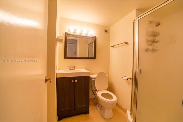 a kitchen with stainless steel appliances granite countertop a refrigerator a sink a stove and white cabinets