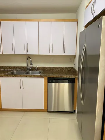 a kitchen with stainless steel appliances granite countertop a stove top oven microwave and cabinets