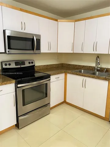 a view of an empty room with glass door
