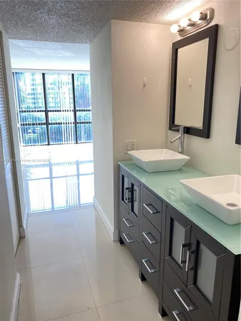 a en suite bathroom with a double vanity sink and a mirror