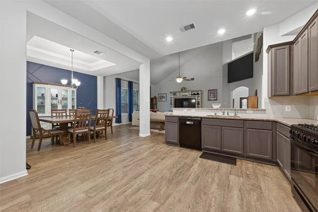 a kitchen with stainless steel appliances kitchen island granite countertop a sink and cabinets