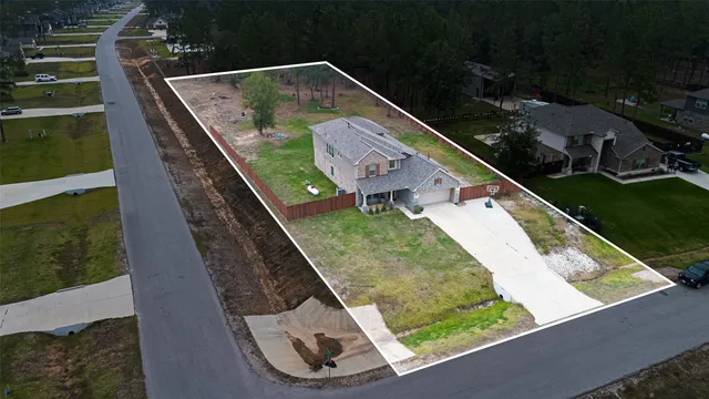 an aerial view of a house with a garden and mountain view in back