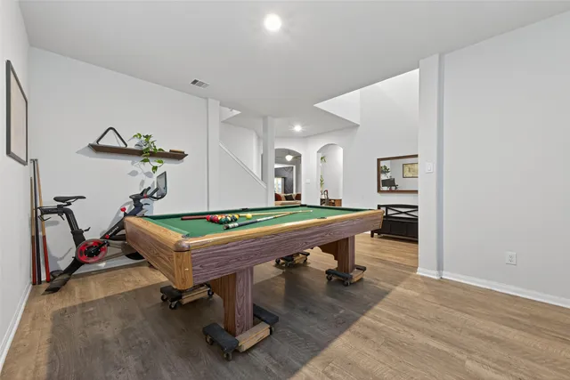 a room with pool table and windows