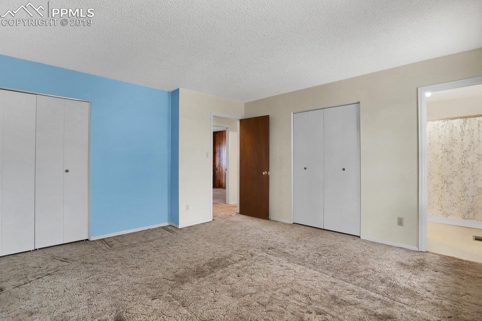 2409 Ranch Lane Colorado Springs, CO 80918 - Photo 14 of 25 Master bedroom is 13 ft. by 13 ft. with access to bathroom.