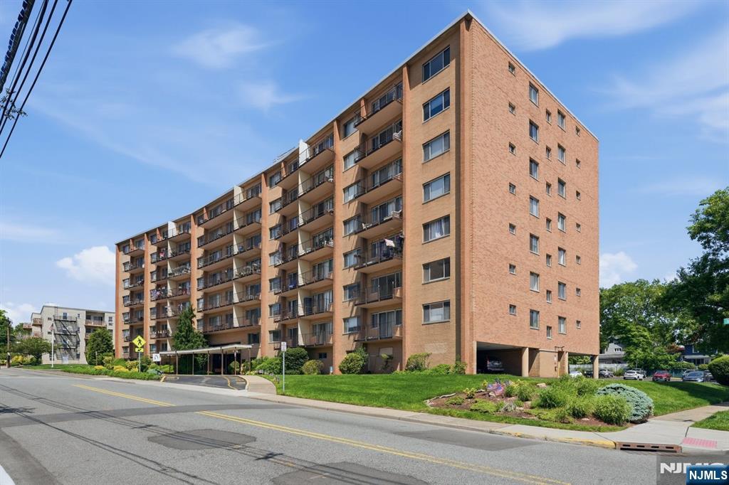 a view of a tall building next to a yard