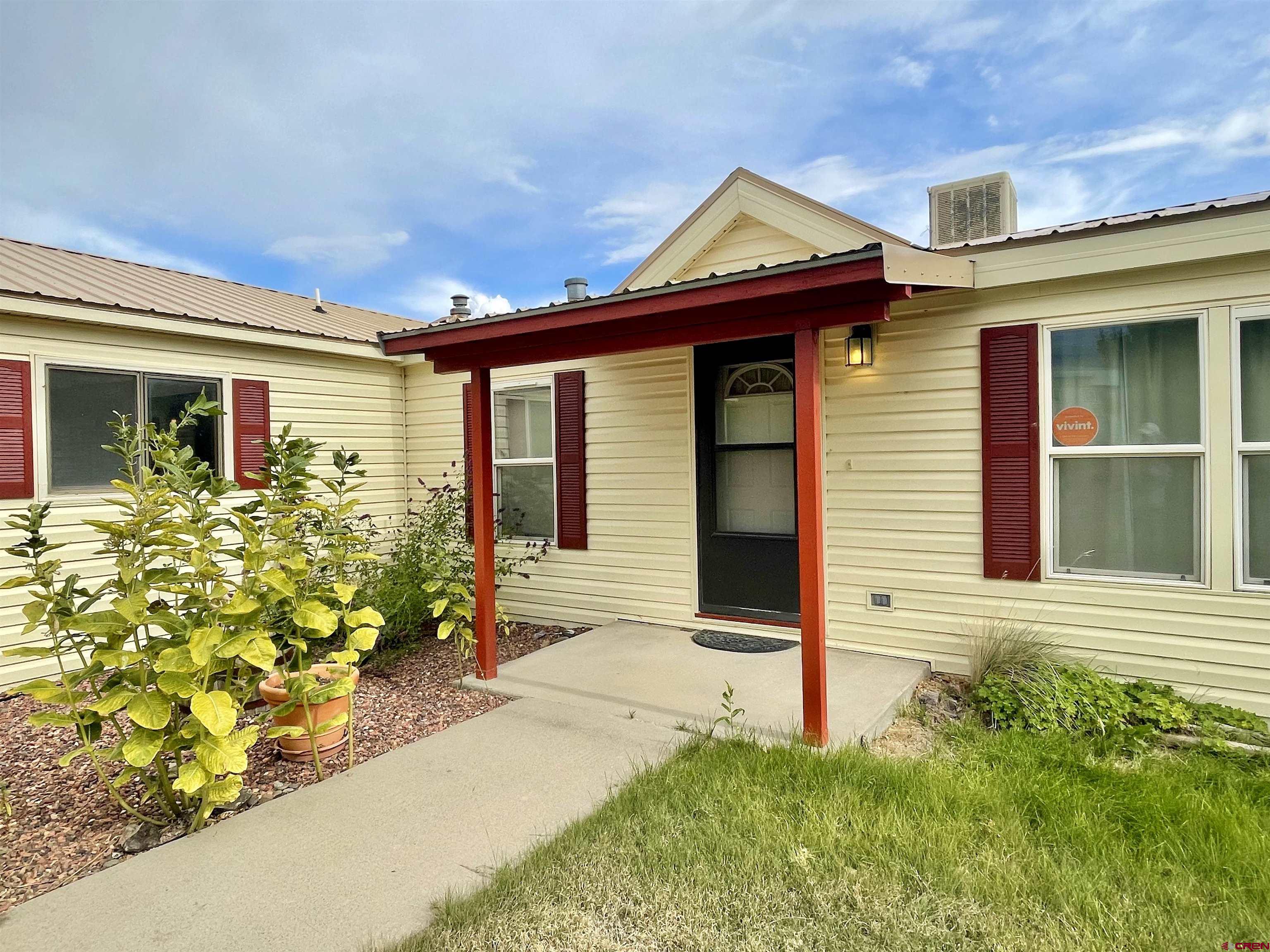 9108 1995th Road Austin, CO 81410 - Photo 3 of 35 a front view of a house with garden